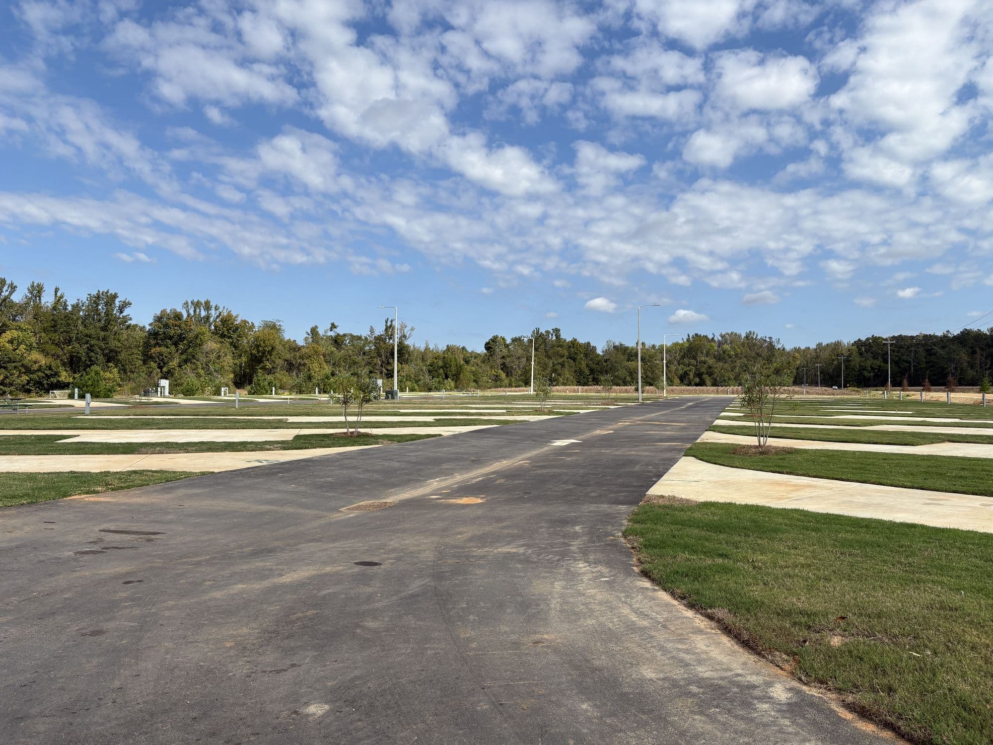 The paved loop road with concrete RV pads and grass on both sides