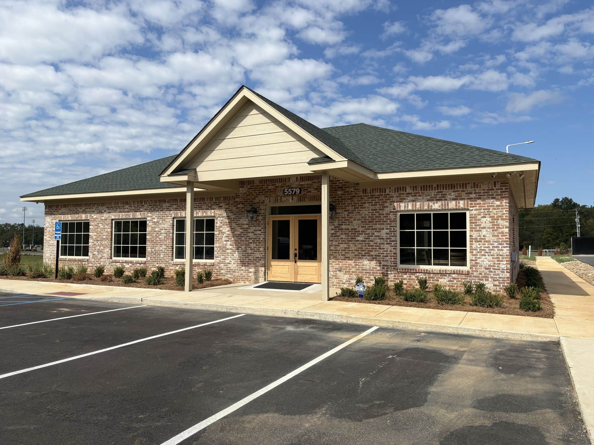 The brick park office with its covered porch at the entrance to Evergreens RV Park