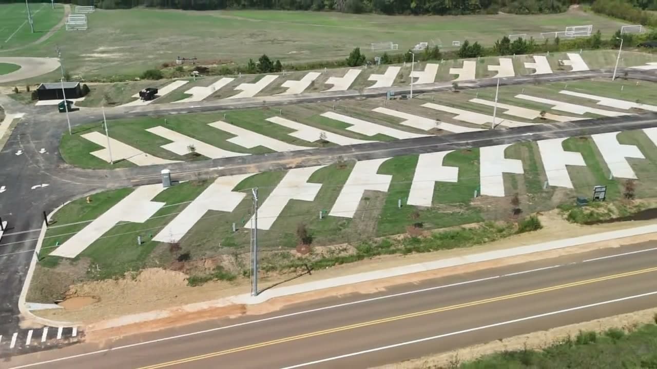Aerial view of the outside ring of concrete RV pads between the paved loop and Pat Patterson Parkway