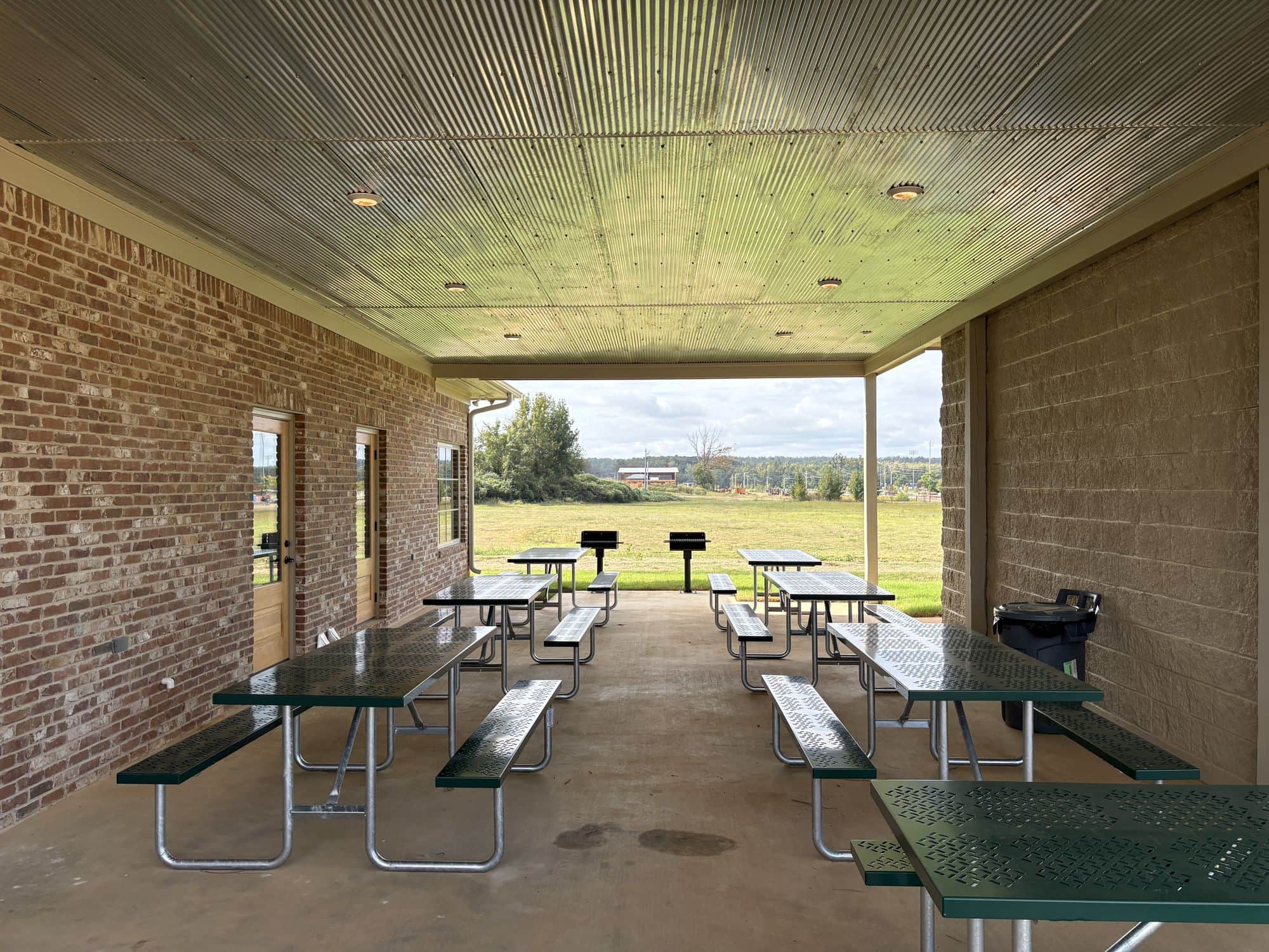 The covered pavilion at Evergreens RV Park, with picnic tables and grills